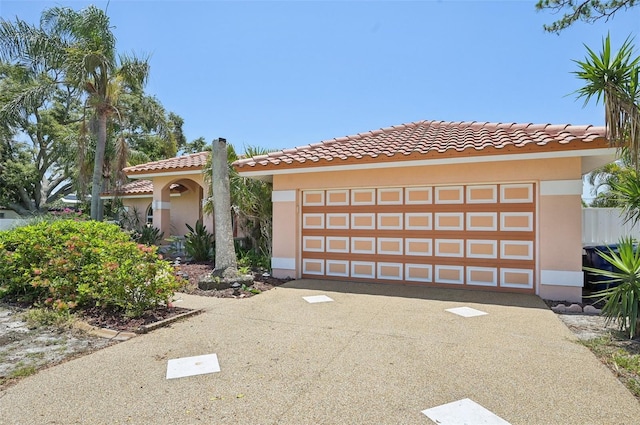 321 Sorrento Dr, Osprey, FL 34229 - mediterranean / spanish house featuring stucco siding, a tiled roof, and driveway