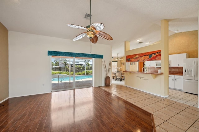321 Sorrento Dr, Osprey, FL 34229 - unfurnished living room featuring a ceiling fan and light tile patterned floors
