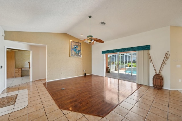 321 Sorrento Dr, Osprey, FL 34229 - spare room featuring light tile patterned floors, a ceiling fan, lofted ceiling, and baseboards