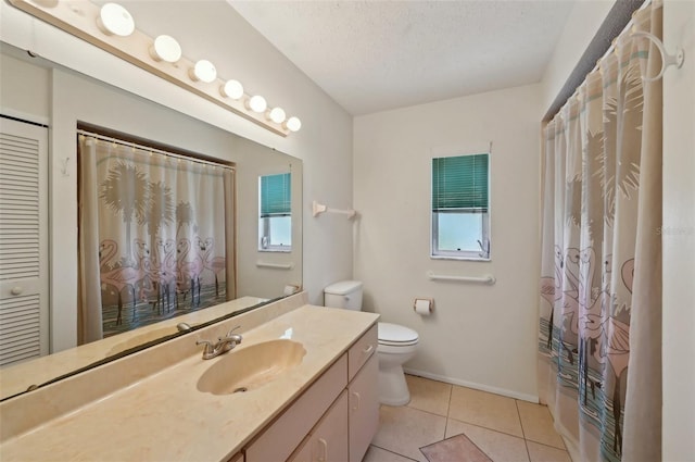 321 Sorrento Dr, Osprey, FL 34229 - full bathroom featuring toilet, vanity, plenty of natural light, tile patterned floors, and a textured ceiling