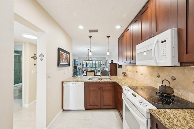 1170 Bird Bay Way Unit 206, Venice, FL 34285 - kitchen featuring white appliances, a sink, light stone countertops, decorative backsplash, and pendant lighting