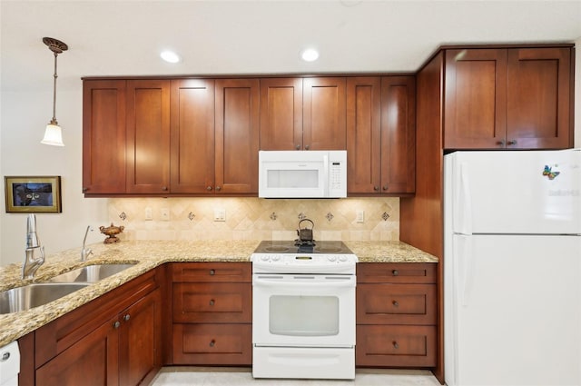 1170 Bird Bay Way Unit 206, Venice, FL 34285 - kitchen with white appliances, a sink, light stone counters, backsplash, and recessed lighting