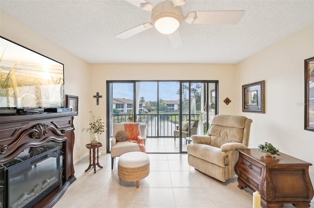 1170 Bird Bay Way Unit 206, Venice, FL 34285 - living area with light tile patterned floors, ceiling fan, a textured ceiling, and a water view