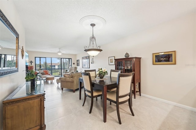 1170 Bird Bay Way Unit 206, Venice, FL 34285 - dining room with a ceiling fan, baseboards, and a textured ceiling