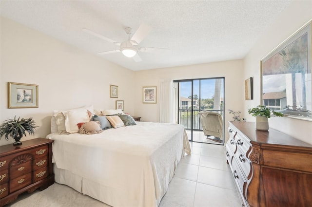 1170 Bird Bay Way Unit 206, Venice, FL 34285 - bedroom with access to exterior, a textured ceiling, light tile patterned flooring, and a ceiling fan