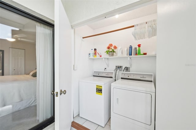 1170 Bird Bay Way Unit 206, Venice, FL 34285 - laundry room with washing machine and dryer and light tile patterned floors
