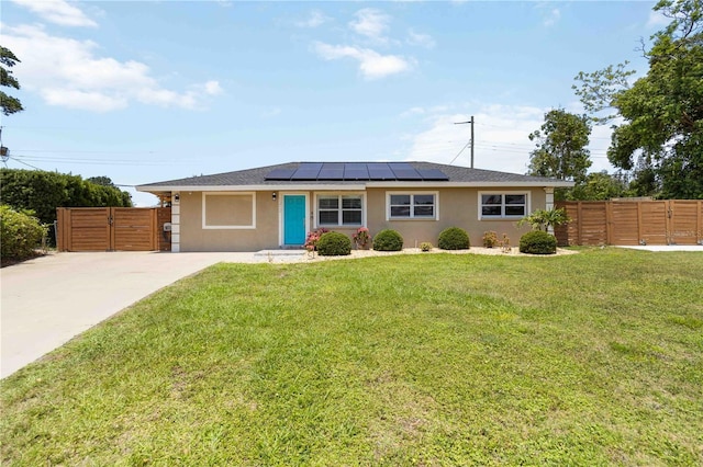 1212 Princeton Ave, Bradenton, FL 34207 - single story home with stucco siding, roof mounted solar panels, and a gate