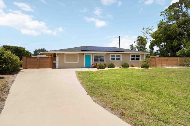 1212 Princeton Ave, Bradenton, FL 34207 - ranch-style home featuring concrete driveway, solar panels, stucco siding, and a gate
