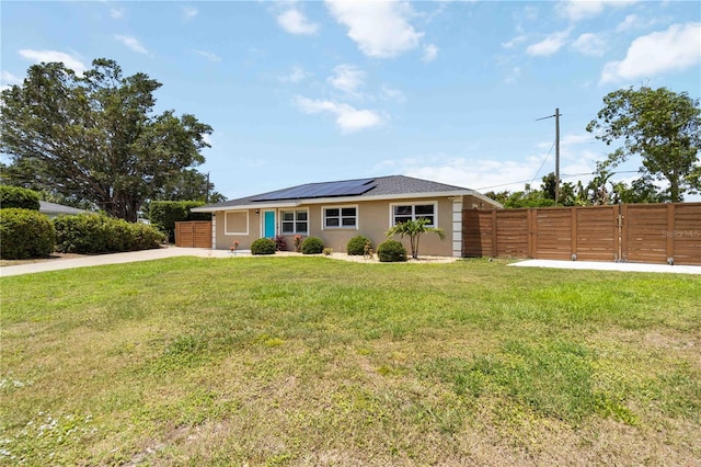 1212 Princeton Ave, Bradenton, FL 34207 - ranch-style home with roof mounted solar panels, concrete driveway, and stucco siding
