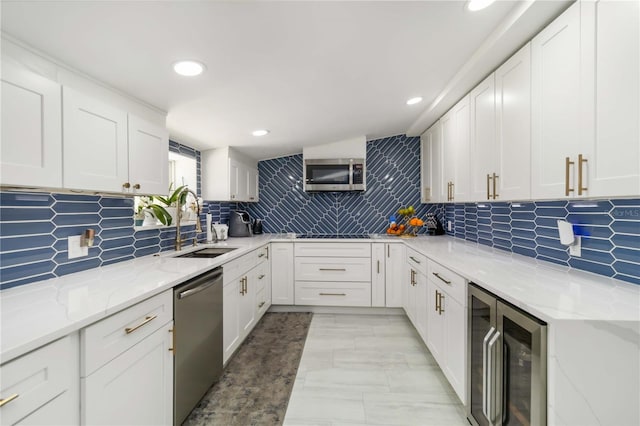 1212 Princeton Ave, Bradenton, FL 34207 - kitchen with appliances with stainless steel finishes, beverage cooler, a sink, light stone countertops, and backsplash