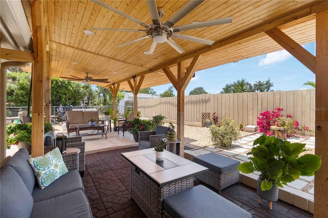 1212 Princeton Ave, Bradenton, FL 34207 - fenced backyard featuring an outdoor hangout area, ceiling fan, and a patio area