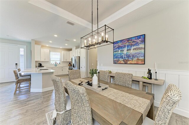 3027 Formia Ct, Lakewood Ranch, FL 34211 - dining area featuring a chandelier, light wood-type flooring, crown molding, and recessed lighting