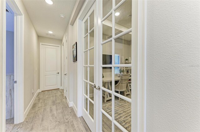 3027 Formia Ct, Lakewood Ranch, FL 34211 - hall featuring french doors, light wood-style flooring, and recessed lighting