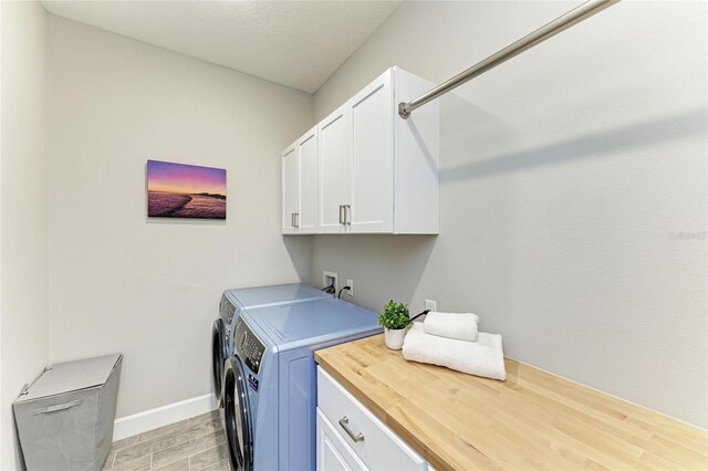 3027 Formia Ct, Lakewood Ranch, FL 34211 - laundry area featuring cabinet space, washing machine and clothes dryer, and light wood-style flooring