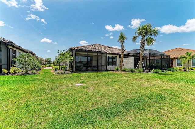 3027 Formia Ct, Lakewood Ranch, FL 34211 - rear view of house with a yard and glass enclosure