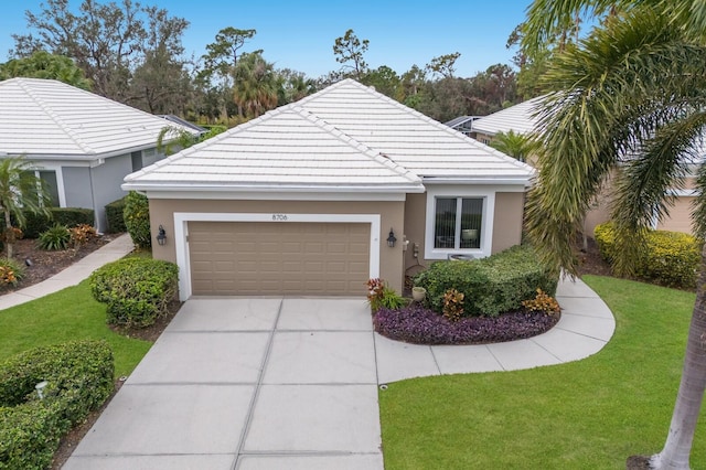 ranch-style home featuring a garage, a front yard, a tile roof, and driveway