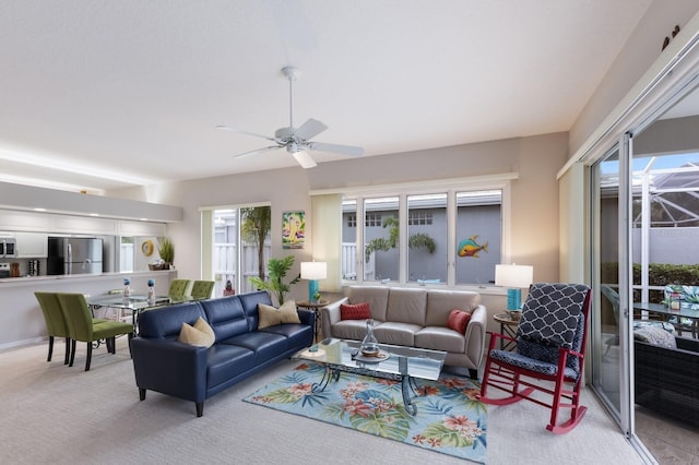 carpeted living room featuring ceiling fan