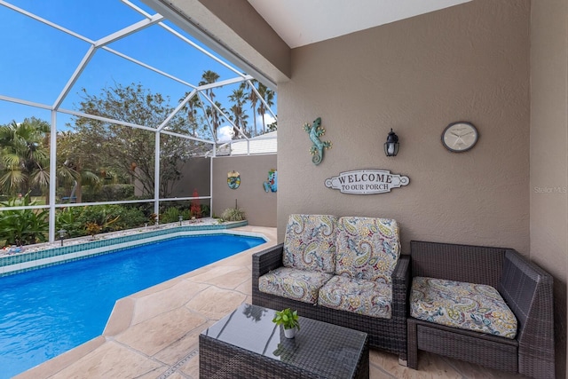 swimming pool with a patio, outdoor lounge area, and a lanai