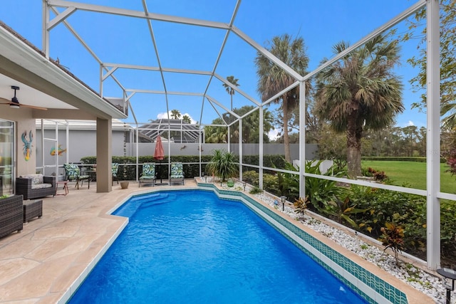 view of swimming pool with a patio, a ceiling fan, and a lanai