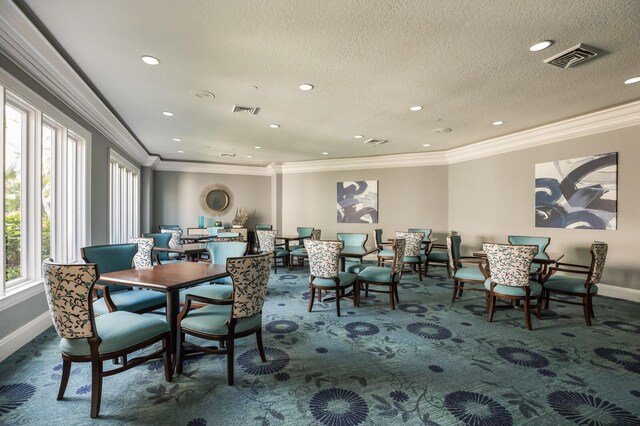 dining area featuring dark colored carpet, baseboards, ornamental molding, recessed lighting, and a textured ceiling