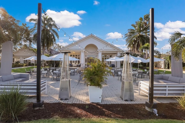 surrounding community featuring outdoor dining space, an outdoor hangout area, and a patio