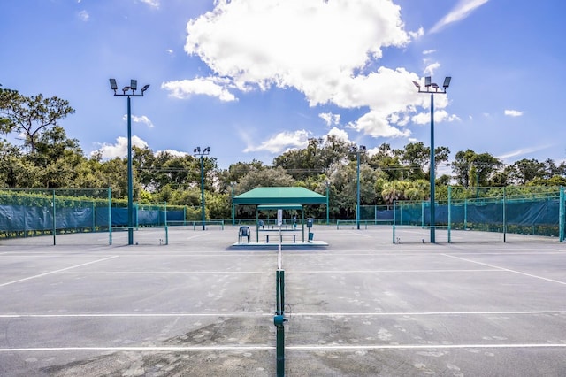 view of tennis court featuring fence
