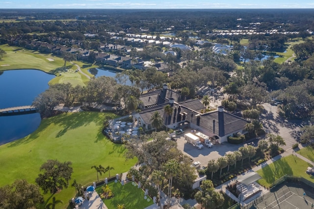 view of property location featuring a golf course and a nearby body of water