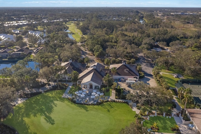 view of property location with a golf club, a nearby body of water, and nearby suburban area