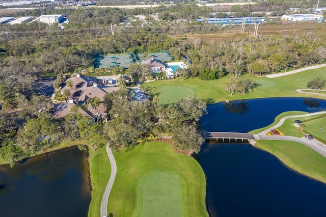 view of property location featuring a large body of water, a local golf course, and a tree filled landscape