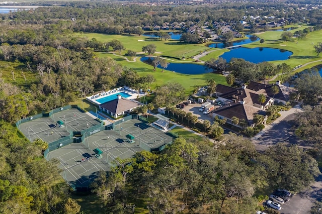 aerial perspective of suburban area featuring a nearby body of water and a local golf course