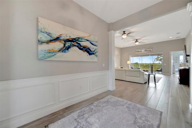 23233 Banbury Way Unit 302, Venice, FL 34293 - hallway with wainscoting and light wood finished floors