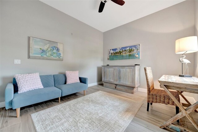 23233 Banbury Way Unit 302, Venice, FL 34293 - living area featuring a ceiling fan, baseboards, light wood-style floors, and high vaulted ceiling