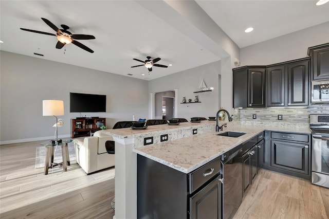 23233 Banbury Way Unit 302, Venice, FL 34293 - kitchen with a sink, appliances with stainless steel finishes, a peninsula, ceiling fan, and recessed lighting