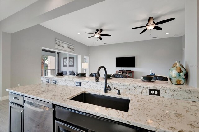 23233 Banbury Way Unit 302, Venice, FL 34293 - kitchen featuring a sink, open floor plan, stainless steel dishwasher, a ceiling fan, and light stone countertops