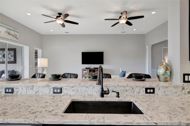 23233 Banbury Way Unit 302, Venice, FL 34293 - kitchen featuring a sink, open floor plan, a ceiling fan, light stone counters, and recessed lighting