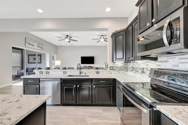 23233 Banbury Way Unit 302, Venice, FL 34293 - kitchen featuring stainless steel appliances, a sink, open floor plan, a ceiling fan, and recessed lighting