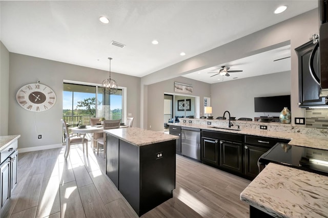 23233 Banbury Way Unit 302, Venice, FL 34293 - kitchen featuring dishwasher, a sink, dark cabinets, a center island, and a ceiling fan