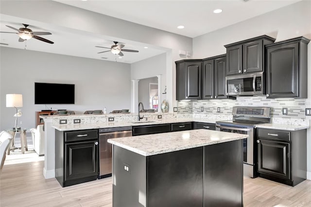 23233 Banbury Way Unit 302, Venice, FL 34293 - kitchen featuring appliances with stainless steel finishes, a sink, open floor plan, ceiling fan, and recessed lighting