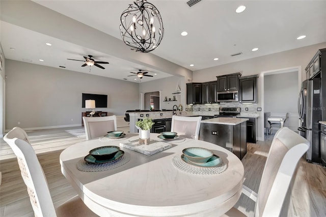 23233 Banbury Way Unit 302, Venice, FL 34293 - dining space with light wood-style floors, a ceiling fan, recessed lighting, baseboards, and a chandelier