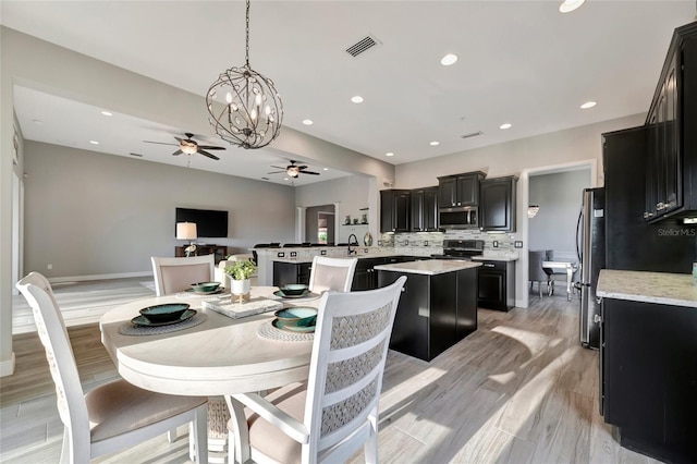 23233 Banbury Way Unit 302, Venice, FL 34293 - dining room with ceiling fan, recessed lighting, baseboards, light wood finished floors, and a chandelier