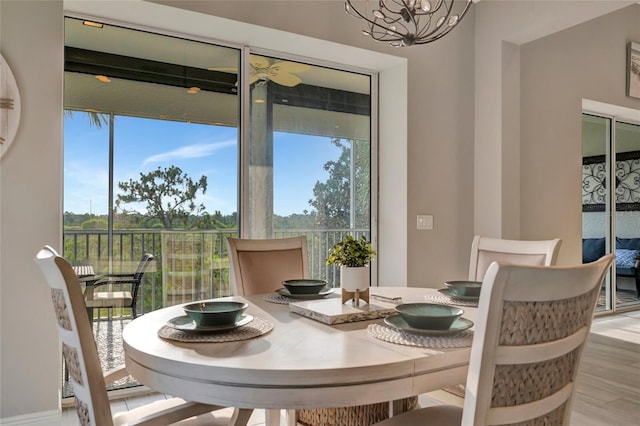 23233 Banbury Way Unit 302, Venice, FL 34293 - dining space featuring wood finished floors and a chandelier