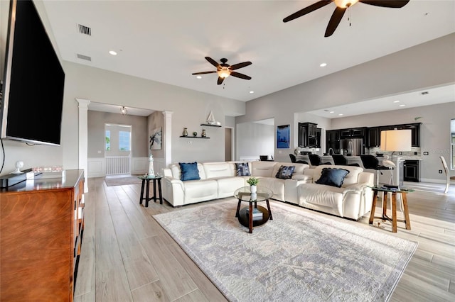 23233 Banbury Way Unit 302, Venice, FL 34293 - living room with a ceiling fan, light wood-style flooring, a wainscoted wall, and recessed lighting
