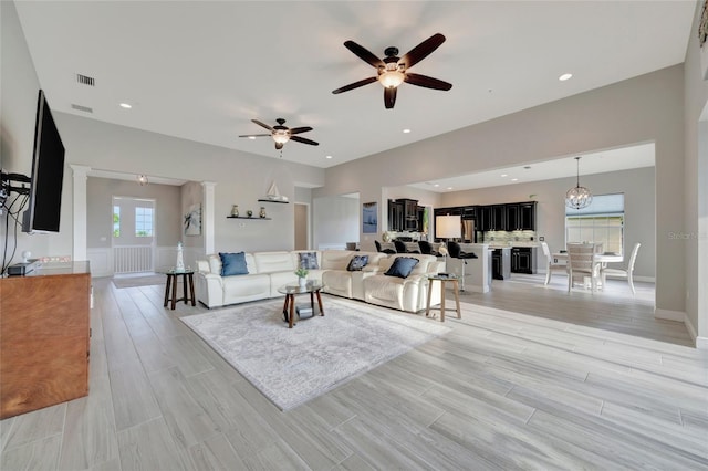 23233 Banbury Way Unit 302, Venice, FL 34293 - living room featuring a ceiling fan and light wood finished floors