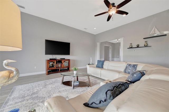 23233 Banbury Way Unit 302, Venice, FL 34293 - living room with ceiling fan, baseboards, wood finished floors, and ornate columns