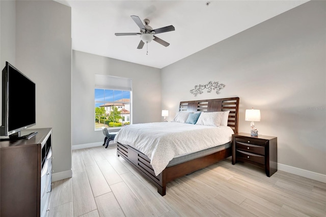 23233 Banbury Way Unit 302, Venice, FL 34293 - bedroom featuring baseboards, light wood-style floors, and a ceiling fan