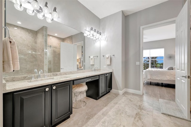 23233 Banbury Way Unit 302, Venice, FL 34293 - full bath with double vanity, tiled shower, ensuite bathroom, baseboards, and marble finish floors