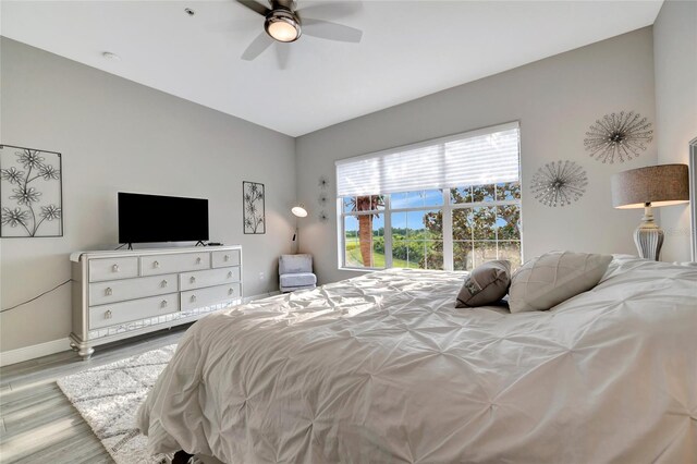 23233 Banbury Way Unit 302, Venice, FL 34293 - bedroom with wood finished floors, baseboards, and a ceiling fan