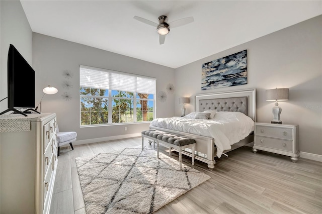 23233 Banbury Way Unit 302, Venice, FL 34293 - bedroom featuring baseboards, light wood-style flooring, and ceiling fan