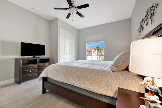 23233 Banbury Way Unit 302, Venice, FL 34293 - bedroom featuring wood finished floors, baseboards, a closet, and ceiling fan