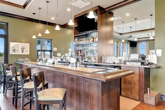 23233 Banbury Way Unit 302, Venice, FL 34293 - community bar area with ornamental molding, decorative light fixtures, recessed lighting, decorative backsplash, and light wood-style flooring